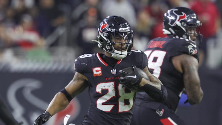 Jan 11, 2025; Houston, Texas, USA; Houston Texans running back Joe Mixon (28) runs with the ball during the game against the Los Angeles Chargers in an AFC wild card game at NRG Stadium. Mandatory Credit: Troy Taormina-Imagn Images