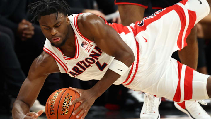 Dec 20, 2025; Phoenix, Arizona, USA; Arizona Wildcats forward Dwayne Aristode (2) dives for a loose ball against San Diego State Aztecs guard Taj DeGourville (24) as head coach Brian Dutcher reacts in the second half during the Hall of Fame Series at Mortgage Matchup Center. Mandatory Credit: Mark J. Rebilas-Imagn Images