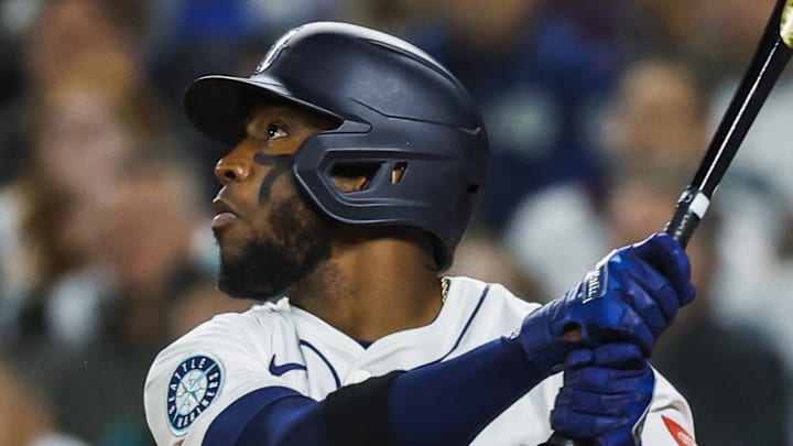 Seattle Mariners right fielder Victor Robles hits a sacrifice fly against the Athletics on March 27 at T-Mobile Park. Seattle Mariners right fielder Victor Robles hits a sacrifice fly against the Athletics on March 27 at T-Mobile Park.