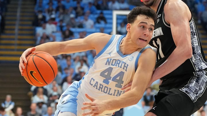 Dec 7, 2025; Chapel Hill, North Carolina, USA; North Carolina Tar Heels guard Luka Bogavac (44) with the ball as Georgetown Hoyas center Julius Halaifonua (11) defends in the second half at Dean E. Smith Center. Mandatory Credit: Bob Donnan-Imagn Images Dec 7, 2025; Chapel Hill, North Carolina, USA; North Carolina Tar Heels guard Luka Bogavac (44) with the ball as Georgetown Hoyas center Julius Halaifonua (11) defends in the second half at Dean E. Smith Center. Mandatory Credit: Bob Donnan-Imagn Images