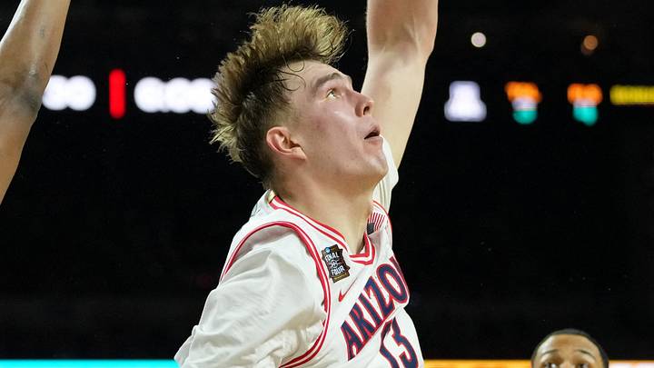 Apr 4, 2026; Indianapolis, IN, USA; Arizona Wildcats center Motiejus Krivas (13) reaches for the ball against Michigan Wolverines forward Morez Johnson Jr. (21) during the first half in a semifinal of the Final Four of the men's 2026 NCAA Tournament at Lucas Oil Stadium. Mandatory Credit: Bob Donnan-Imagn Images Apr 4, 2026; Indianapolis, IN, USA; Arizona Wildcats center Motiejus Krivas (13) reaches for the ball against Michigan Wolverines forward Morez Johnson Jr. (21) during the first half in a semifinal of the Final Four of the men's 2026 NCAA Tournament at Lucas Oil Stadium. Mandatory Credit: Bob Donnan-Imagn Images