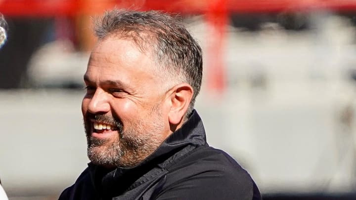 Northwestern Wildcats interim head coach David Braun and Nebraska football coach Matt Rhule talk