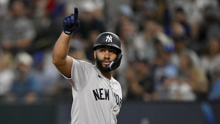 Aug 4, 2025; Arlington, Texas, USA; New York Yankees right fielder Amed Rosario (14) points to the dugout after he hits a double against the Texas Rangers during the second inning at Globe Life Field. Mandatory Credit: Jerome Miron-Imagn Images