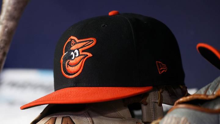 May 5, 2023; Atlanta, Georgia, USA; A detailed view of a Baltimore Orioles hat and glove in the dugout during a game against the Atlanta Braves in the seventh inning at Truist Park. 