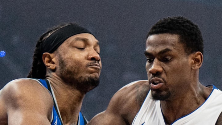 Detroit Pistons center Jalen Duren dribbles the ball against Orlando Magic center-forward Wendell Carter Jr.