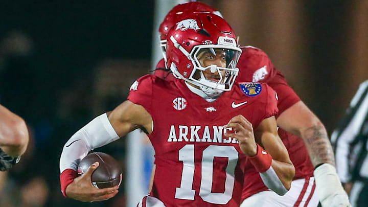 Arkansas Razorbacks quarterback Taylen Green (10) runs the ball for a first down as Texas Tech Red Raiders linebacker Charles Esters III (11) pursues during the second quarter at Simmons Bank Liberty Stadium. Arkansas Razorbacks quarterback Taylen Green (10) runs the ball for a first down as Texas Tech Red Raiders linebacker Charles Esters III (11) pursues during the second quarter at Simmons Bank Liberty Stadium.