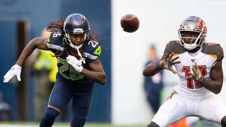 Nov 3, 2019; Seattle, WA, USA; Tampa Bay Buccaneers wide receiver Chris Godwin (12) catches a pass while being defended by Seattle Seahawks cornerback Shaquill Griffin (26) during the second half at CenturyLink Field. Seattle defeated Tampa Bay 40-34.