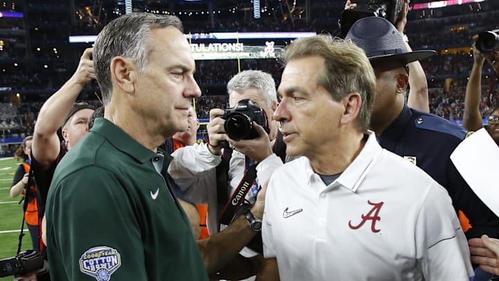 Dec 31, 2015; Arlington, TX, USA; Michigan State Spartans head coach Mark Dantonio (left) and Alabama Crimson Tide head coach Nick Saban (right) shake hands after the 2015 CFP semifinal at the Cotton Bowl at AT&T Stadium. Mandatory Credit: Tim Heitman-Imagn Images