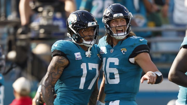 Oct 27, 2024; Jacksonville, Florida, USA; Jacksonville Jaguars tight end Evan Engram (17) and quarterback Trevor Lawrence (16) celebrate a touchdown against the Green Bay Packers during the fourth quarter at EverBank Stadium. Mandatory Credit: Morgan Tencza-Imagn Images