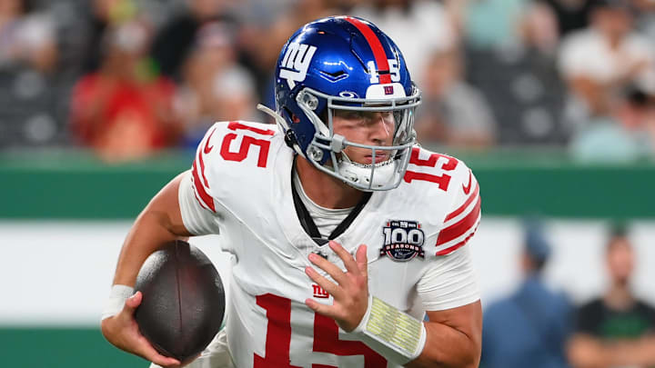 Aug 24, 2024; East Rutherford, New Jersey, USA; New York Giants quarterback Tommy DeVito (15) runs with the ball against the New York Jets during the second half at MetLife Stadium. Mandatory Credit: Rich Barnes-Imagn Images