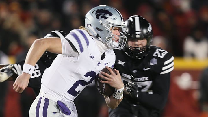 Kansas State Wildcats quarterback Avery Johnson (2) runs with the ball around Iowa State Cyclones linebacker Will McLaughlin (23) during the first quarter in the NCAA football at Jack Trice Stadium on Saturday, Nov. 30, 2024, in Ames, Iowa.