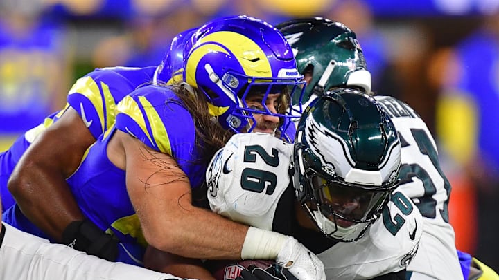 Nov 24, 2024; Inglewood, California, USA; Philadelphia Eagles running back Saquon Barkley (26) is brought down by Los Angeles Rams linebacker Christian Rozeboom (56) during the second half at SoFi Stadium. Mandatory Credit: Gary A. Vasquez-Imagn Images Nov 24, 2024; Inglewood, California, USA; Philadelphia Eagles running back Saquon Barkley (26) is brought down by Los Angeles Rams linebacker Christian Rozeboom (56) during the second half at SoFi Stadium. Mandatory Credit: Gary A. Vasquez-Imagn Images