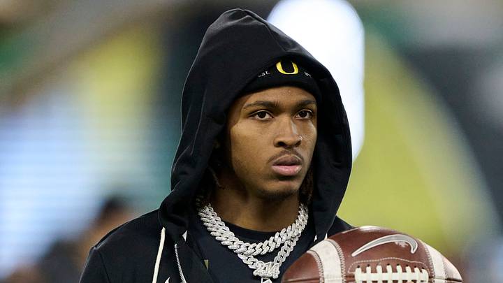 Nov 14, 2025; Eugene, Oregon, USA; Oregon Ducks wide receiver Dakorien Moore watches teammates warm up before a game against the Minnesota Golden Gophers at Autzen Stadium. Nov 14, 2025; Eugene, Oregon, USA; Oregon Ducks wide receiver Dakorien Moore watches teammates warm up before a game against the Minnesota Golden Gophers at Autzen Stadium.