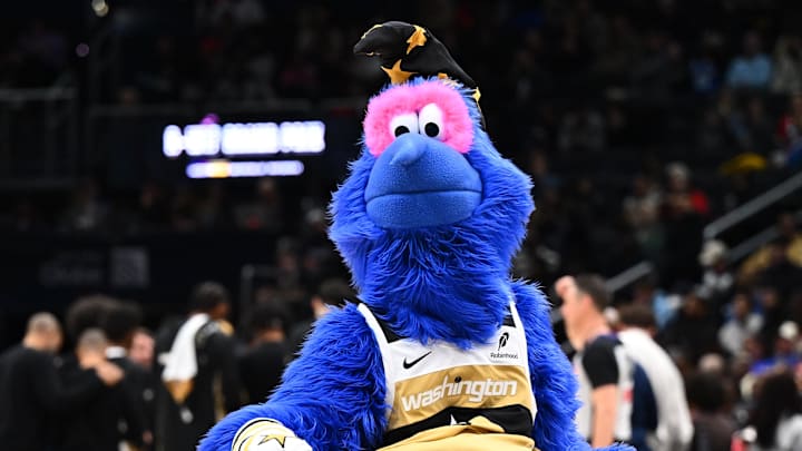 Dec 28, 2025; Washington, District of Columbia, USA; Washington Wizards mascot G-Wiz on the court against the Memphis Grizzlies during the second half at Capital One Arena. Mandatory Credit: Brad Mills-Imagn Images
