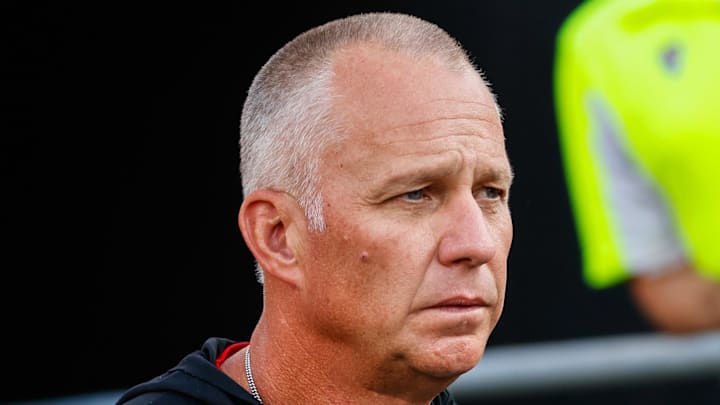 Aug 28, 2025; Raleigh, North Carolina, USA; North Carolina State Wolfpack head coach Dave Doeren walks out during the warmups prior to the game against East Carolina Pirates at Carter-Finley Stadium. Mandatory Credit: Jaylynn Nash-Imagn Images