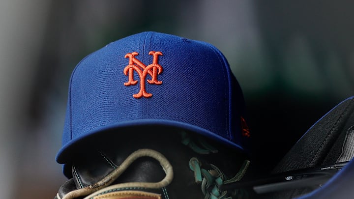 A New York Mets hat and glove in the dugout in the second inning against the Colorado Rockies at Coors Field in 2024. 