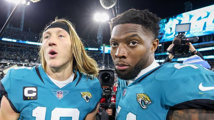 Jan 14, 2023; Jacksonville, Florida, USA; Jacksonville Jaguars quarterback Trevor Lawrence (16) and linebacker Josh Allen (41) celebrate after beating the Los Angeles Chargers in a wild card game at TIAA Bank Field. 