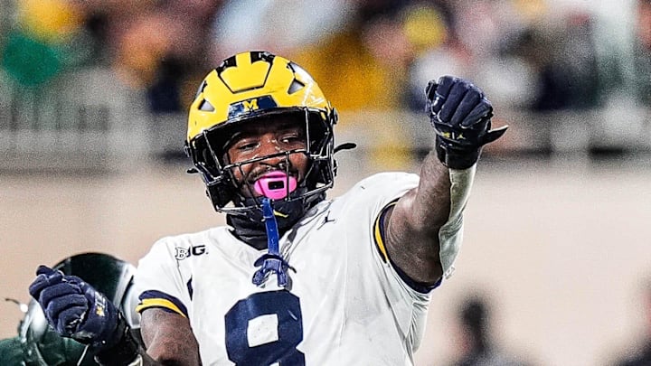 Michigan edge Derrick Moore (8) celebrates a sack against Michigan State quarterback Alessio Milivojevic (11) during the second half at Spartan Stadium in East Lansing on Saturday, October 25, 2025. Michigan edge Derrick Moore (8) celebrates a sack against Michigan State quarterback Alessio Milivojevic (11) during the second half at Spartan Stadium in East Lansing on Saturday, October 25, 2025.