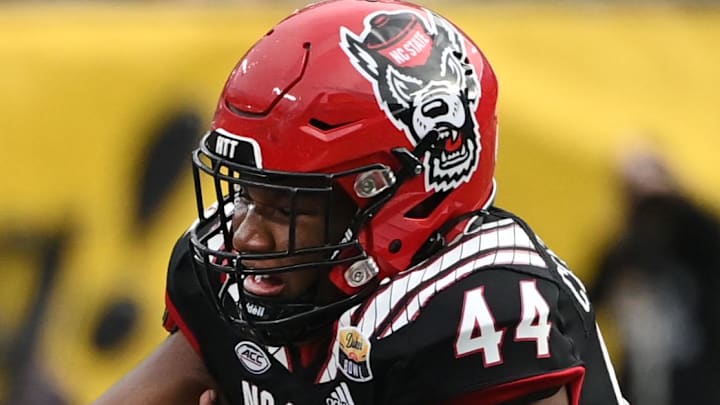 Dec 30, 2022; Charlotte, NC, USA; Maryland Terrapins quarterback Taulia Tagovailoa (3) scrambles as North Carolina State Wolfpack defensive lineman Brandon Cleveland (44) defends in the fourth quarter in the 2022 Duke's Mayo Bowl at Bank of America Stadium. Mandatory Credit: Bob Donnan-Imagn Images Dec 30, 2022; Charlotte, NC, USA; Maryland Terrapins quarterback Taulia Tagovailoa (3) scrambles as North Carolina State Wolfpack defensive lineman Brandon Cleveland (44) defends in the fourth quarter in the 2022 Duke's Mayo Bowl at Bank of America Stadium. Mandatory Credit: Bob Donnan-Imagn Images