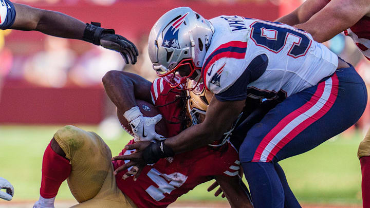 Sep 29, 2024; Santa Clara, California, USA; San Francisco 49ers running back Jordan Mason (24) is tackled by New England Patriots defensive end Keion White (99) during the fourth quarter at Levi's Stadium. Mandatory Credit: Neville E. Guard-Imagn Images