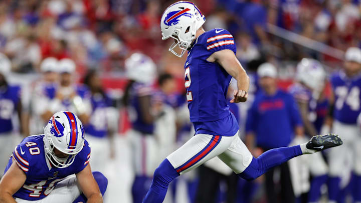Buffalo Bills place kicker Tyler Bass attempts a field goal held by punter Brad Robbins against the Tampa Bay Buccaneers.