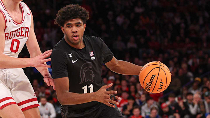 Jan 25, 2025; New York, New York, USA; Michigan State Spartans guard Jase Richardson (11) drives to the basket against Rutgers Scarlet Knights guard Jordan Derkack (0) during the second half at Madison Square Garden. Mandatory Credit: Vincent Carchietta-Imagn Images