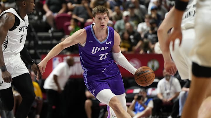 Jul 14, 2025; Las Vegas, NV, USA;  Utah Jazz forward Kyle Filipowski (22) dribbles the ball against San Antonio Spurs forward Osayi Osifo (26) during the first half of a NBA basketball game at Thomas & Mack Center. Mandatory Credit: Lucas Peltier-Imagn Images