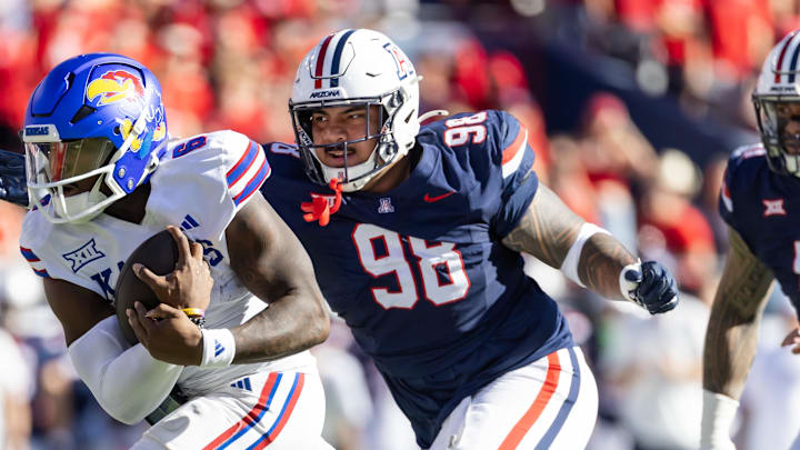 Nov 8, 2025; Tucson, Arizona, USA; Kansas Jayhawks quarterback Jalon Daniels (6) against Arizona Wildcats defensive lineman Tiaoalii Savea (98) at Arizona Stadium. Mandatory Credit: Mark J. Rebilas-Imagn Images