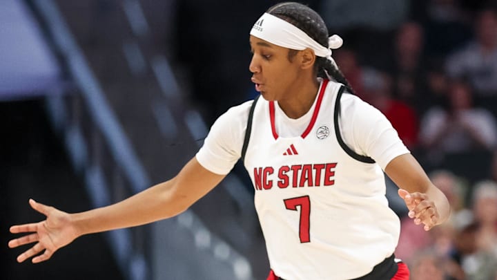 Nov 9, 2025; Charlotte, North Carolina, USA; NC State Wolfpack guard Destiny Lunan (7) loses the ball against the Southern California Trojans during the second quarter of the Ally Tipoff game at Spectrum Center. Mandatory Credit: Cory Knowlton-Imagn Images