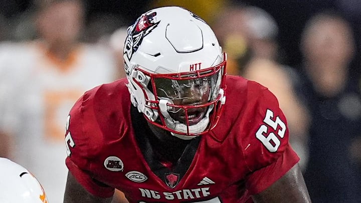 Sep 7, 2024; Charlotte, North Carolina, USA; North Carolina State Wolfpack offensive tackle Jacarrius Peak (65) lines up against Tennessee Volunteers defensive lineman Bryson Eason (20) during the first quarter at the Dukes Mayo Classic at Bank of America Stadium. Mandatory Credit: Jim Dedmon-Imagn Images