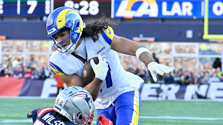 Nov 17, 2024; Foxborough, Massachusetts, USA;  New England Patriots cornerback Marco Wilson (22) tries to tackle Los Angeles Rams wide receiver Puka Nacua (17) during the first half at Gillette Stadium. Mandatory Credit: Eric Canha-Imagn Images