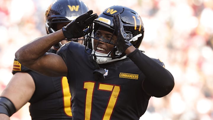 Dec 1, 2024; Landover, Maryland, USA; Washington Commanders wide receiver Terry McLaurin (17) celebrates with fans in the stands after scoring a touchdown against Tennessee Titans during the first half at Northwest Stadium. Mandatory Credit: Amber Searls-Imagn Images
