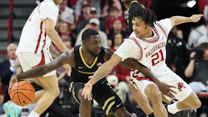 Vanderbilt Commodores guard Duke Miles (2) drives against Arkansas Razorbacks guard D.J. Wagner (21) during the first half at Bud Walton Arena.