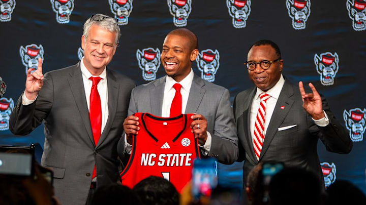 NC State AD Boo Corrigan, men's basketball coach Justin Gainey and Chancellor Kevin Howell pose at Gainey's introductory press conference at the Lenovo Center on Wednesday, April 1, 2026. 