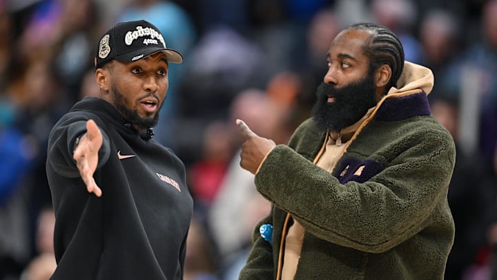 Feb 27, 2026; Detroit, Michigan, USA;   Cleveland Cavaliers guard Donovan Mitchell (left) talks with teammate James Harden during a timeout against the Detroit Pistons in the second half at Little Caesars Arena. Neither played in their overtime loss to the Pistons. Mandatory Credit: Lon Horwedel-Imagn Images