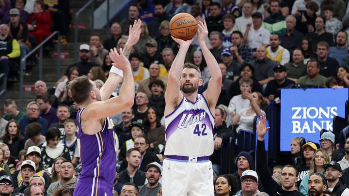 Dec 18, 2025; Salt Lake City, Utah, USA;  Utah Jazz forward/center Kevin Love (42) shoots against Los Angeles Lakers forward/guard Luka Doncic (77) during the second half at Delta Center. Mandatory Credit: Chris Nicoll-Imagn Images