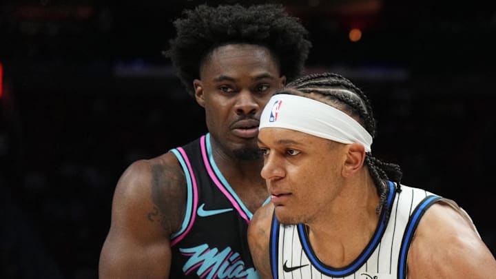 Orlando Magic forward Paolo Banchero drives past Miami Heat guard Davion Mitchell. Orlando Magic forward Paolo Banchero drives past Miami Heat guard Davion Mitchell.