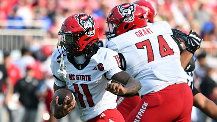 Sep 20, 2025; Durham, North Carolina, USA;  North Carolina State Wolfpack quarter back CJ Bailey (11) runs the ball against the Duke Blue Devils during the first quarter at Wallace Wade Stadium. Mandatory Credit: Zachary Taft-Imagn Images