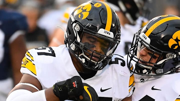 Nov 21, 2020; University Park, Pennsylvania, USA; Iowa Hawkeyes defensive lineman Chauncey Golston (57) celebrates a defensive play with teammate linebacker Seth Benson (44) against the Penn State Nittany Lions during the first quarter at Beaver Stadium. Mandatory Credit: Rich Barnes-Imagn Images
