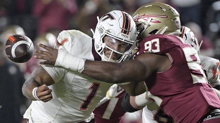 Nov 15, 2025; Tallahassee, Florida, USA; Virginia Tech Hokies quarterback Kyron Drones (1) has the ball knocked away by Florida State Seminoles defensive lineman Mandrell Desir (93) during the second half at Doak S. Campbell Stadium. Mandatory Credit: Melina Myers-Imagn Images Nov 15, 2025; Tallahassee, Florida, USA; Virginia Tech Hokies quarterback Kyron Drones (1) has the ball knocked away by Florida State Seminoles defensive lineman Mandrell Desir (93) during the second half at Doak S. Campbell Stadium. Mandatory Credit: Melina Myers-Imagn Images