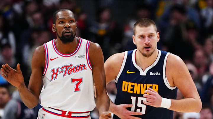 Dec 15, 2025; Denver, Colorado, USA; Houston Rockets forward Kevin Durant (7) and Denver Nuggets center Nikola Jokic (15) during the second quarter at Ball Arena.