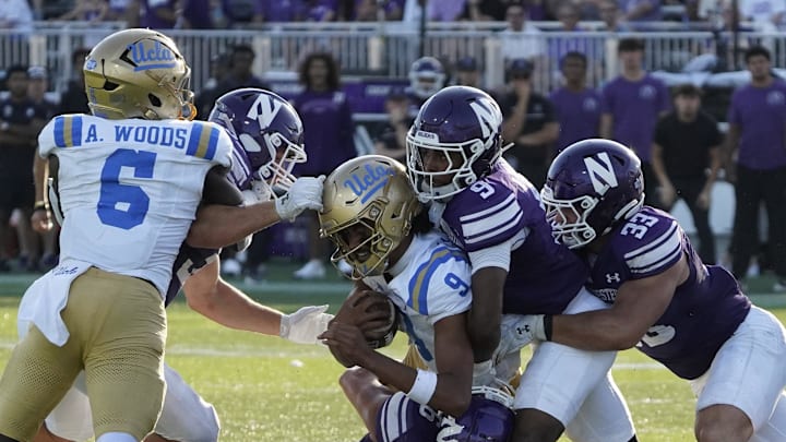 Sep 27, 2025; Evanston, Illinois, USA; Northwestern Wildcats defensive back Braden Turner (9) tackles UCLA Bruins quarterback Nico Iamaleava (9) during the second half at Northwestern Medicine Field at Martin Stadium. Mandatory Credit: David Banks-Imagn Images Sep 27, 2025; Evanston, Illinois, USA; Northwestern Wildcats defensive back Braden Turner (9) tackles UCLA Bruins quarterback Nico Iamaleava (9) during the second half at Northwestern Medicine Field at Martin Stadium. Mandatory Credit: David Banks-Imagn Images