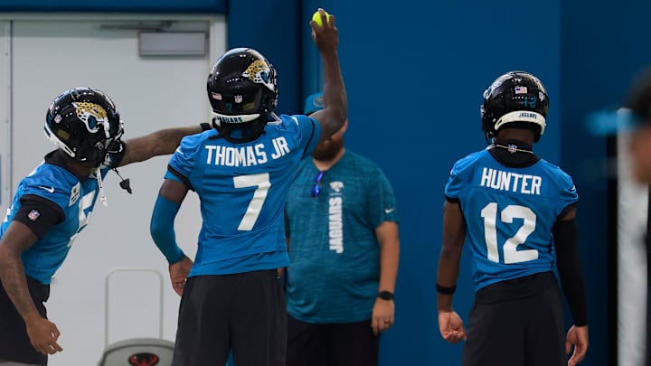 From left, Jacksonville Jaguars wide receiver Dyami Brown (5), wide receiver Brian Thomas Jr. (7) and wide receiver Travis Hunter (12) participate in a reflex exercise with a tennis ball during the 10th organized team activity at Miller Electric Center Wednesday, June 4, 2025 in Jacksonville, Fla. [Corey Perrine/Florida Times-Union]