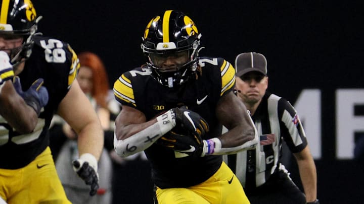 Dec 2, 2023; Indianapolis, IN, USA; Iowa Hawkeyes running back Kaleb Johnson (2) runs during the first half of the Big Ten Championship game against the Michigan Wolverines at Lucas Oil Stadium. Mandatory Credit: Trevor Ruszkowski-Imagn Images