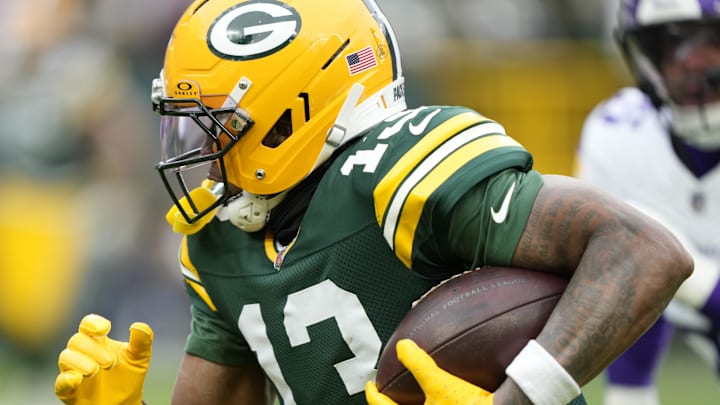Green Bay Packers receiver Dontayvion Wicks (13) runs after the catch against the Minnesota Vikings on Sunday.