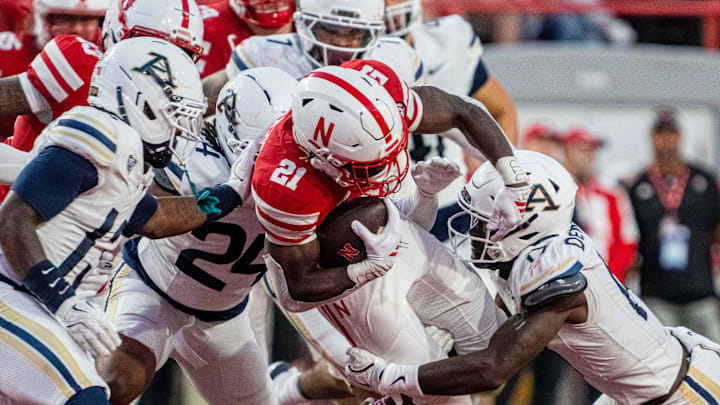 Nebraska Cornhuskers running back Emmett Johnson runs against Akron Zips defensive back Malcom DeWalt IV.