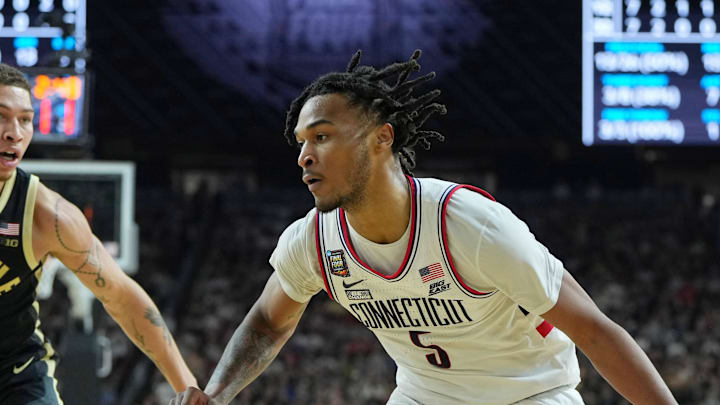 Apr 8, 2024; Glendale, AZ, USA; Connecticut Huskies guard Stephon Castle (5) dribbles the ball against Purdue Boilermakers guard Myles Colvin (5) during the first half of the national championship game of the Final Four of the 2024 NCAA Tournament at State Farm Stadium. Mandatory Credit: Bob Donnan-USA TODAY Sports