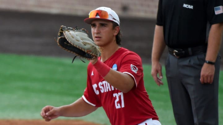 Stetson Hatters' Isaiah Barkett (13) drives back safely to first as NC State Wolfpack's Chris McHugh (27) waits on the pickoff attempt during the NCAA Baseball Regional Tournament at Plainsman Park in Auburn, Ala., on Friday May 30, 2025.