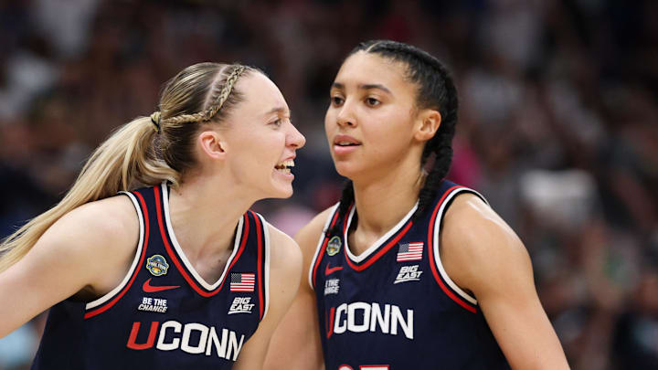 Apr 6, 2025; Tampa, FL, USA; Connecticut Huskies guard Paige Bueckers (5) reacts with teammates guard Ashlynn Shade (12) and guard Azzi Fudd (35) during the second half against the South Carolina Gamecocks of the national championship of the women's 2025 NCAA tournament at Amalie Arena. Mandatory Credit: Nathan Ray Seebeck-Imagn Images