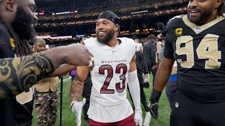 Dec 15, 2024; New Orleans, Louisiana, USA; New Orleans Saints linebacker Demario Davis (56) greets former teammate Washington Commanders cornerback Marshon Lattimore (23) next to New Orleans Saints defensive end Cameron Jordan (94) at the end of the game at Caesars Superdome. Mandatory Credit: Matthew Hinton-Imagn Images